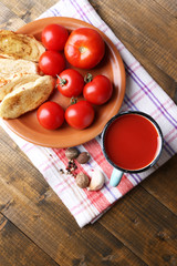 Homemade tomato juice in color mug, toasts and fresh tomatoes