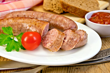 Sausages pork fried in plate on board with bread
