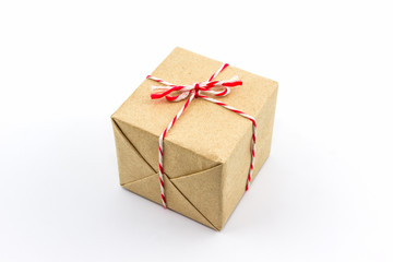 Cardboard carton wrapped with brown paper, tied with string.