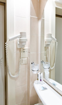White Hair Dryer on wall in bathroom. SPA