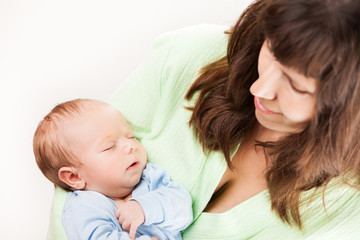 Fototapeta na wymiar Cute sleeping newborn baby child on mother hands