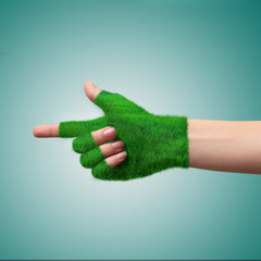 Go Green Concept.Hand in glove grass indicates the direction.
