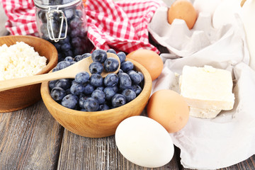 Fresh blueberries and milk products on wooden table