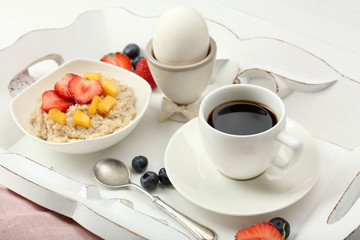 Delicious breakfast with coffee, egg and oatmeal