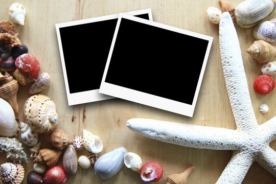 photo frames on the wooden background with seashells around