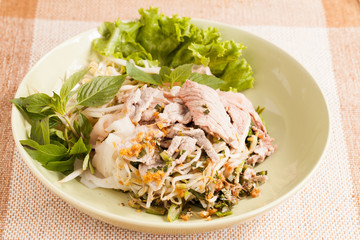 A dish of noodles and pork.