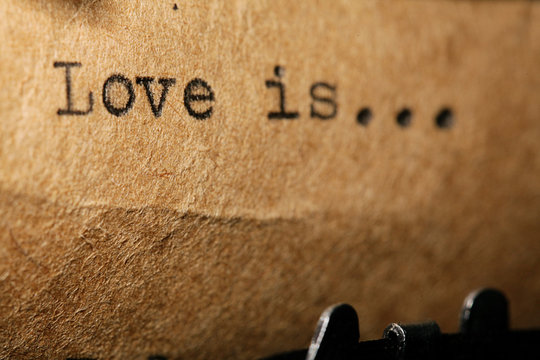 Naklejka love is, the inscription on a typewriter