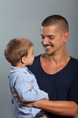 Fototapeta premium Portrait of young father and cute little son