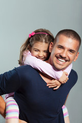 Portrait of young father and cute little doughter