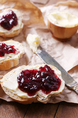 Fresh bread with homemade butter and blackcurrant jam