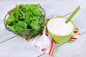 Green pan of cream and a tuft of dill and garlic