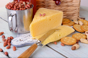 Cheese and crackers on wooden table close-up