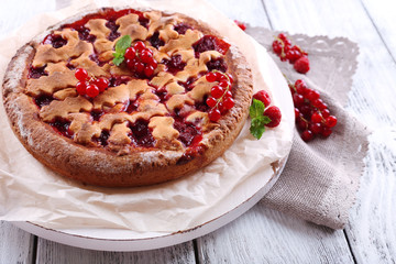 Tasty cake with berries on table close-up