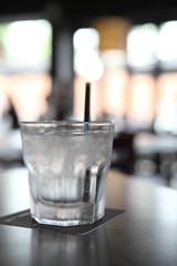 Water in glass in wood background