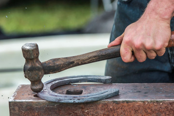 Horse shoe being made by blacksmith