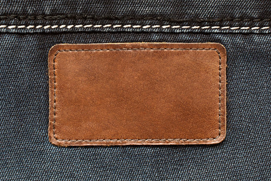 Leather tag on jeans background
