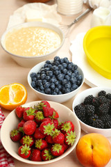 Baking tasty pie and ingredients for it on table in kitchen