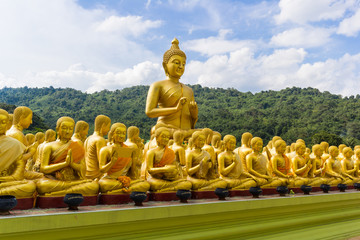 golden statue of monks and buddha