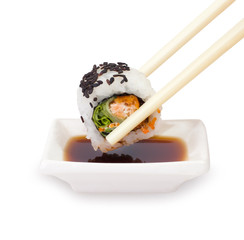 Chopsticks with sushi on a white background