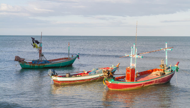 Small fishing boats moored along the shore.
