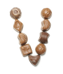 Alphabet letter V arranged from chocolate sweets isolated