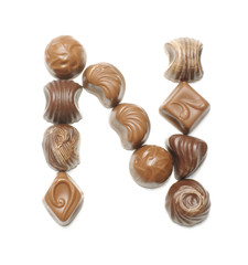 Alphabet letter N arranged from chocolate sweets isolated