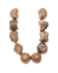 Alphabet letter U arranged from chocolate sweets isolated