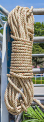 Coil of rope hanging on steel.