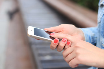 Close up of a woman using mobile smart phone