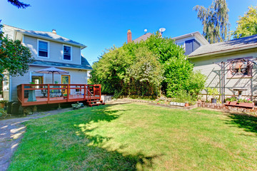 Fototapeta na wymiar House with backyard walkout deck and patio area