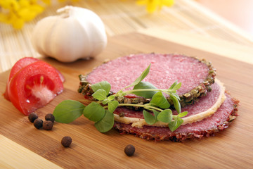 Slices of salami on wooden table