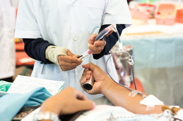 Obraz na płótnie Canvas Staff taking blood sample from blood donation