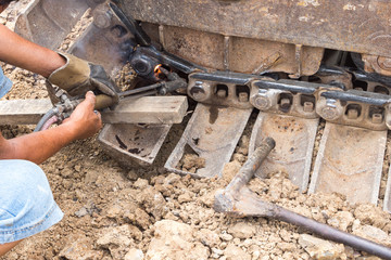 Fixing bulldozer wheel with gas cutting torch