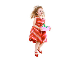 Cheerful little girl jumping with a gift