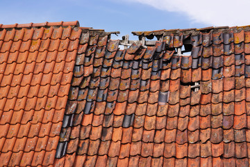 Damaged tiled roof of an old Dutch house