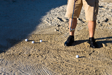 Golfer practicing from the sand bunker