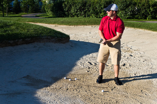 Golfer practicing from the sand bunker