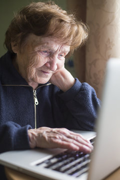 Old Woman Working On The Computer.