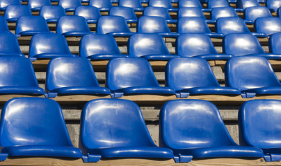 Naklejka premium empty blue seats at sports stadium