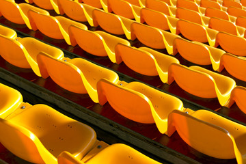 Fototapeta na wymiar empty yellow seats at sports stadium
