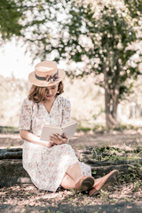 Vintage girl reading book in park