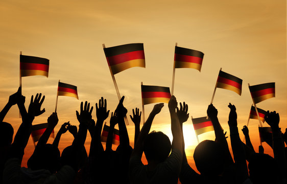 Group of People Waving German Flags in Back Lit