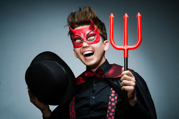 Funny devil against dark background