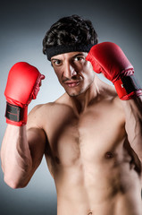 Muscular boxer wiith red gloves