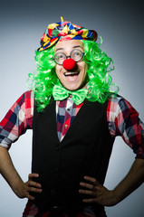 Fototapeta na wymiar Funny clown against the dark background