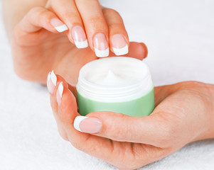 Female hands holding jar of cream