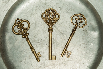 Three golden keys on iron plate