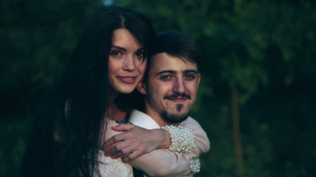 Man and woman having fun, cuddling, looking at you