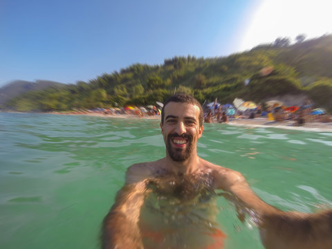 Young Man Taking Selfie in the Water