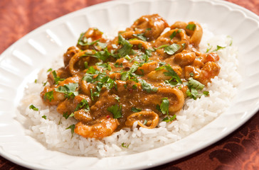 Delicious sea food curry with mango, coconut milk and white rice as side
